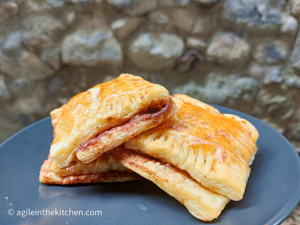 On a blue plate a pile of cinnamon rectangles.