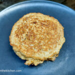 On a blue matte plate, a oat and brown sugar pancake.